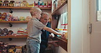 Family, grandfather and boy grandchild in a sweets shop together for retail or commercial shopping as customers. Children, bonding and a senior man shopping for candy with his adorable kid grandson