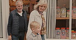 Grandparents, leaving and child happy after candy shopping  at a shop or sweet store. Happy senior man, woman and a boy kid or customer buying sugar treats from business in a city on travel trip