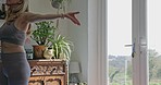 Exercise, yoga and a woman at home for a healthy lifestyle, fitness and wellness in morning. Mature female person stretching in her lounge for a workout and health motivation while thinking at window