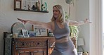 Yoga, exercise and a woman at home with a healthy lifestyle, fitness and wellness with a smile. Mature female person stretching in her lounge for a workout, warrior pose and health motivation