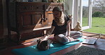 Yoga, home and woman brushing cat or pet to relax after exercise, workout and meditation for wellness. Positive, health and female person touch animal or kitty as love after fitness or training