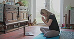 Yoga, laptop and fitness with woman in living room for online class, social media and learning. Workout, meditation and peace with person and video call at home for balance, spiritual and mindfulness