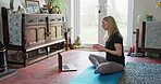 Yoga, laptop and video call with woman in living room for fitness, social media and learning. Workout, meditation and peace with person and online class at home for balance, spiritual and mindfulness