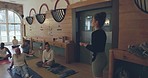 Wellness, yoga instructor and talking to group in a class for meditation, exercise or fitness. Holistic, chakra and relax with people together for mindfulness, healing or zen communication for peace