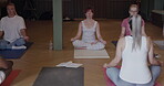 Yoga class, fitness and group of people meditate for health and wellness or holistic exercise. Women and instructor at zen club for mindfulness, workout and healing or relax with lotus meditation