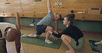 Stretching, coaching and help with teacher in yoga studio for meditation, health and workout. Wellness, spiritual and exercise with group of people in class for pilates, mindfulness and holistic