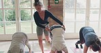 Pilates, wellness and teacher doing exercise with people at studio for mind, body and chakra balance. Health, fitness and calm group stretching for yoga or meditation workout session in a zen gym.