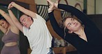 Yoga class, people stretching and exercise together for wellness, health and fitness at gym with personal trainer. Pilates, workout and healthy with zen, healing and coaching, self care and flexible