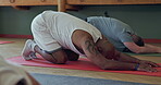 Exercise, fitness and group of people in yoga class for health and wellness. Diversity, men and zen club for mindfulness, workout and healing or relax with child pose, stretching or pilates on floor
