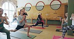 Yoga class, people and stretching with calm, breathing and holistic exercise, workout or balance in lunge for wellness goals. Pilates, training and group relax in fitness, club or gym for sports
