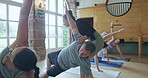 Instructor, help and people stretching in yoga class for fitness, health and wellness. Men and women group at zen club for meditation, workout and healing or relax with balance, exercise and pilates
