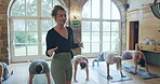 Coaching, yoga and health with woman in class for fitness, meditation and mindfulness. Peace, wellness and learning with group of people in pilates studio for balance, workout and energy exercise