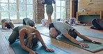 Pilates class, stretching and instructor with people in gym for mind, body and fitness for chakra. Calm, breathe and group of meditation students in position for yoga exercise in zen health studio.