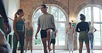 Yoga, warm up and fitness with people in studio for learning, workout and mindfulness. Balance, meditation and peace with instructor in pilates class for coaching, energy and spiritual wellness