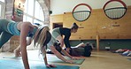 Fitness, men and women in yoga class with instructor at gym, teaching balance and energy in holistic exercise. Training, zen and workout, pilates in studio with coach stretching muscle for body care.