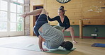 Yoga, fitness and teacher with people in studio for coaching, flexibility or stretching. Meditation, spiritual and mindfulness with instructor helping client in class for workout, health and wellness