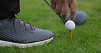 Hands, golf ball and exercise or tee, sports and competition on grass, challenge and tournament. Person, athlete and closeup for game, practice and hobby or recreation, action and equipment for match