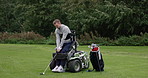 Sports, golf course and man in wheelchair for training, playing game and competition for recreation. Fitness, golfer and person with disability swing with golfing club, ball and hobby for fun