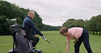 Man, woman and golf on course tee or person with a disability in inclusive sports, coach or practice. Old people, grass field and ball for teaching stroke win or support as elderly, equipment at club