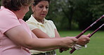 Senior women, golf course and training on a field with club, advice or guidance outdoor. Elderly, friends and woman with golfer instructor on a park for active, learning or retirement hobby practice