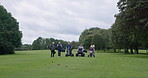 Friends, golf course and walking with club, sports and cart for fitness, competition and practise. Golfer, grass and lawn for training, outdoor and recreation for hobby, golfing and game equipment