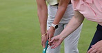 Woman, coach and sport training for golf on course for development in stroke or swing of club. Hands, closeup and personal trainer help player with stick, hit and balls on pitch in sports game