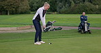 Friends, golf and woman on course with man in wheelchair to play game, training and practice for recreation. Sports, golfer and mature person with golfing club, ball and exercise for fun hobby