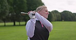 Sports, golf club and a woman golfer swinging outdoor on a course for competition during a game. Summer, training and recreation with a person golfing on a green for a leisure hobby or practice