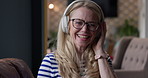 Headphones, face and happy woman singing to music track, wellness podcast or home radio network. Portrait, happiness and relax singer smile, listening and streaming audio, sound or freedom song