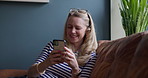 Phone, smile and mature woman networking on social media, mobile app or the internet at home. Relax, technology and female person scroll on website with cellphone on sofa in living room of house.