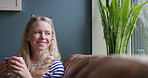 Coffee, thinking and woman with a smile on a sofa with memories, reflection and daydreaming at home. Happy, relax and mature female person drinking a cappuccino in living room of modern apartment.