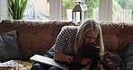 Woman, care and kiss dog on sofa for smile on face for love, remote work and relax in living room. Person, pet and animal with stroke, play and happy with laptop, portrait and lounge couch in home
