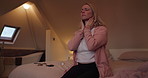 Night, stress or headache and woman in the bedroom of her home feeling exhausted with insomnia. Mental health, pressure or frustration and a tired or sleepless person sitting on a bed in an apartment
