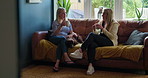 Coffee cup, talking friends and women listening to conversation, communication and consulting on information. Lounge sofa, sitting together and home people share gossip, advice and drink caffeine