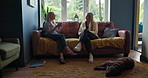 Conversation, relax and girl friends on a sofa in the living room of modern apartment or home. Discussion, coffee and mature women talking, speaking or bonding together in the lounge at house.