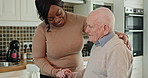 Happy, conversation and nurse with senior man in the kitchen of modern nursing home for assistance. Bonding, smile and black woman caregiver with elderly male person in wheelchair at retirement house