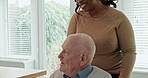 Elderly, man or caregiver with conversation or wheelchair for support, pointing and happy in kitchen. Senior, person or woman with communication, talking and handicap in retirement home for volunteer