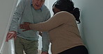 Elderly, man or caregiver for support on stairs with instructions, helping or guide in hospice or house. Senior, person or woman and communication, steps or handicap in retirement home for volunteer