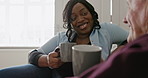 Home, nurse and senior man on a couch, coffee and recovery with healing, conversation and wellness. Black woman, caregiver and pensioner on a sofa, tea and service with health, latte and discussion