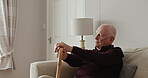Old man, thinking and walking stick in home on sofa with alzheimer, dementia or lonely in retirement. Elderly, depression or senior person with disability in house and mental health stress or anxiety