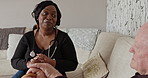 Discussion, healthcare and nurse with elderly man with a walking stick in living room of house. Communication, medical and African caregiver talking to senior male patient in retirement home.