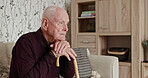 Senior man, thinking and cane in home on sofa with alzheimer, dementia or lonely in retirement. Elderly, depression or senior person with disability in house and mental health stress or anxiety
