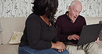 Senior man, learning and laptop with caregiver in home conversation about internet, error or solution. Happy, elderly person and black woman on sofa helping with technology, login or streaming web