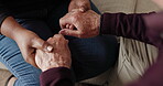 Old person, holding hands and comfort for love support, bad news or grief advice. People, fingers and embrace for empathy kindness on sofa together for care touch, pain help for loss understanding