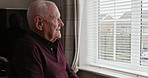 Thinking, window and happy senior man in wheelchair for memory, nostalgia and reflection in nursing home. Retirement, old age and elderly person with disability on room to remember, smile and relax