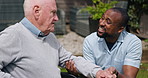Wheelchair, outdoor and nurse with old man, help and recovery with rehabilitation, wellness and support. Pensioner, person with a disability and caregiver with healing, medical service and healthcare