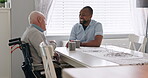 Home, nurse and old man in a wheelchair talking with support, care or healthcare consultation in retirement. Elderly, caregiver and person with a disability and gratitude for help or chat with coffee