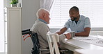 Home, nurse and old man in a wheelchair talking with support, care or healthcare consultation in retirement. Elderly, caregiver and person with a disability with help, kindness or chat with coffee