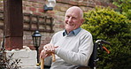 Wheelchair, garden and face of senior man outdoors for relaxing, fresh air and wellness at home. Retirement, nature and portrait of elderly person with smile for calm, peace and sunshine in backyard