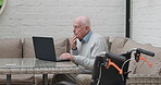 Laptop, wheelchair and a senior man thinking in his home for planning, finance or household budget. Computer, accounting or retirement and an elderly person with a disability in his apartment